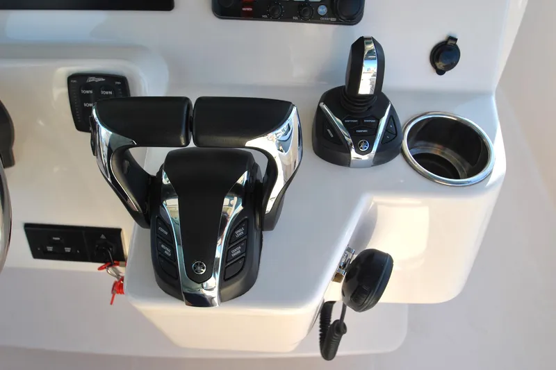 Slide: The Image of Control panel of 2021 Grady-White Canyon 336 boat with throttle and joystick. - 12