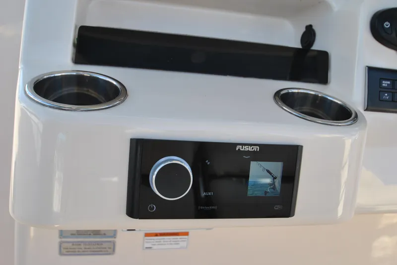Slide: The Image of Control panel of 2021 Grady-White Canyon 336 boat with Fusion audio system and cup holders. - 13
