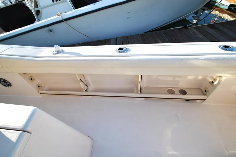 Slide: The Image of 2021 Grady-White Canyon 336 boat interior with rod holders and storage compartment. - 15