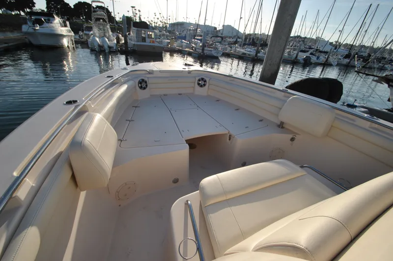 Slide: The Image of 2021 Grady-White Canyon 336 boat interior at marina, showcasing spacious seating and sleek design. - 17