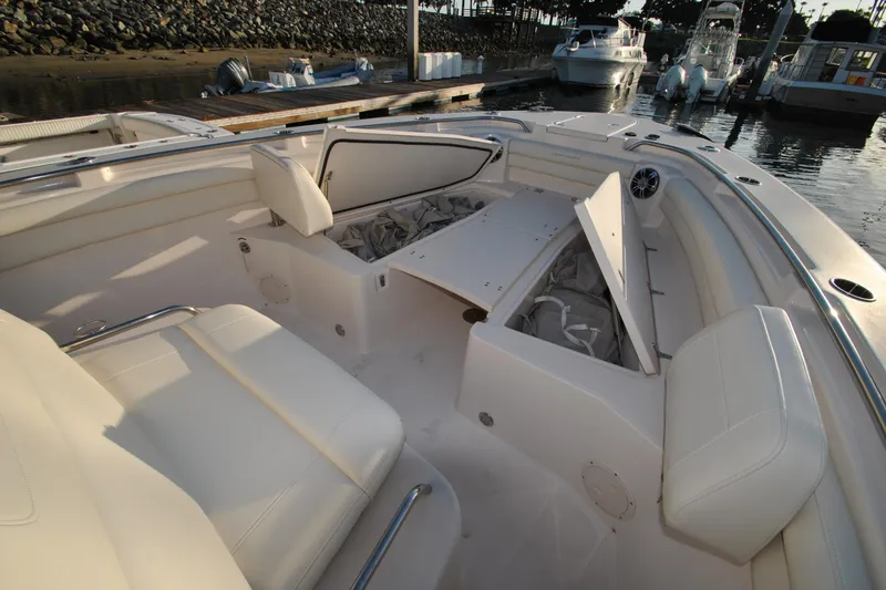 Slide: The Image of 2021 Grady-White Canyon 336 boat interior with open storage compartments at dock. - 18