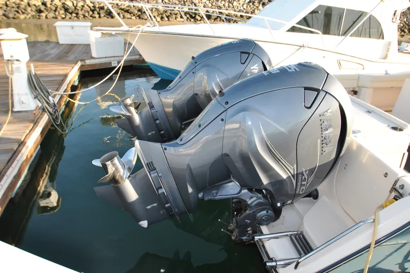 Slide: The Image of 2021 Grady-White Canyon 336 boat with dual Yamaha outboard engines docked at marina. - 2