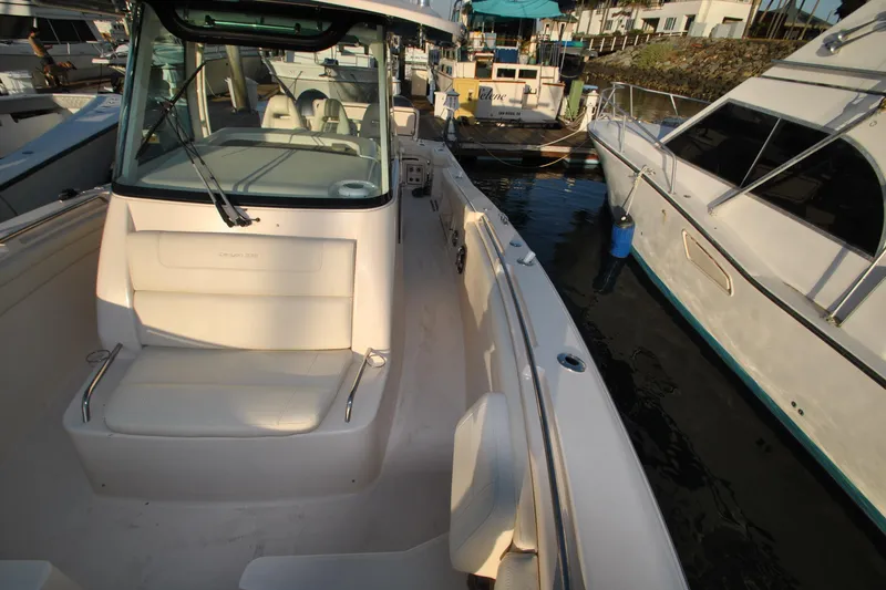 Slide: The Image of 2021 Grady-White Canyon 336 boat docked, showcasing spacious seating and sleek design. - 24