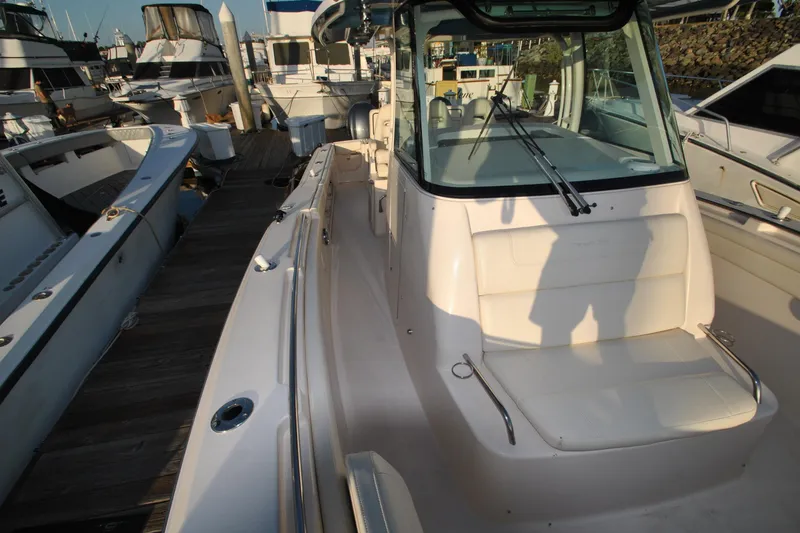Slide: The Image of 2021 Grady-White Canyon 336 boat docked at marina, showcasing sleek design and spacious deck. - 25
