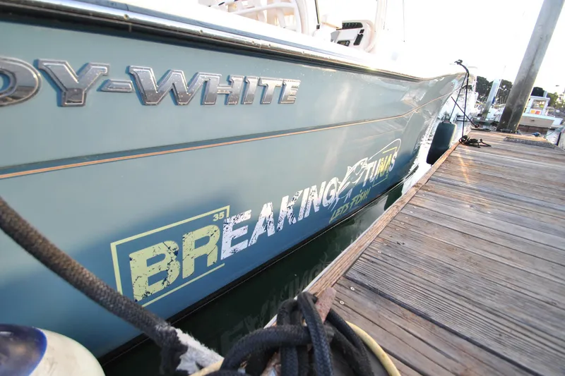 Slide: The Image of 2021 Grady-White Canyon 336 boat docked, showcasing sleek design and branding. - 27