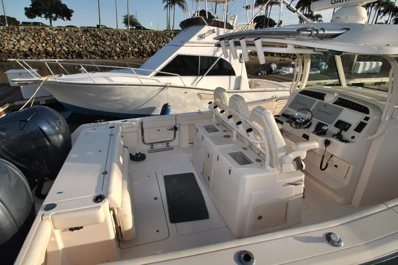 Slide: The Image of 2021 Grady-White Canyon 336 boat interior with helm, seating, and controls at marina. - 28
