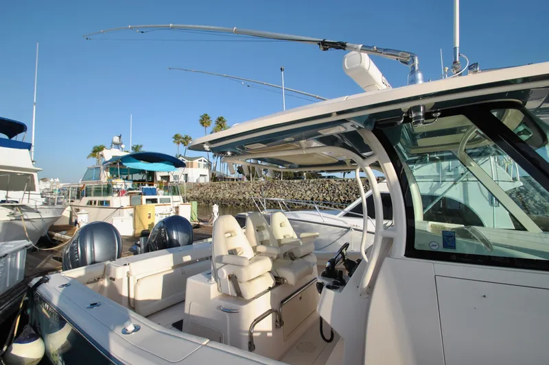 Slide: The Image of 2021 Grady-White Canyon 336 boat docked, featuring dual engines and spacious seating. - 29