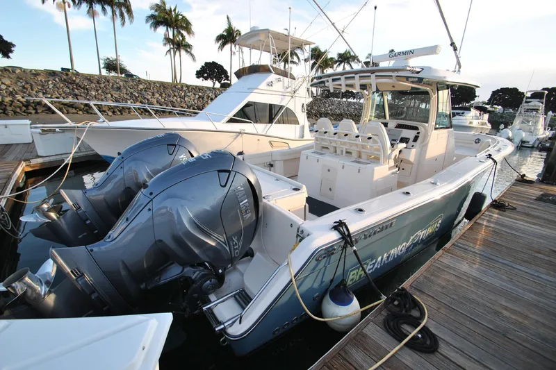 Slide: The Image of 2021 Grady-White Canyon 336 boat docked with dual outboard engines. - 4