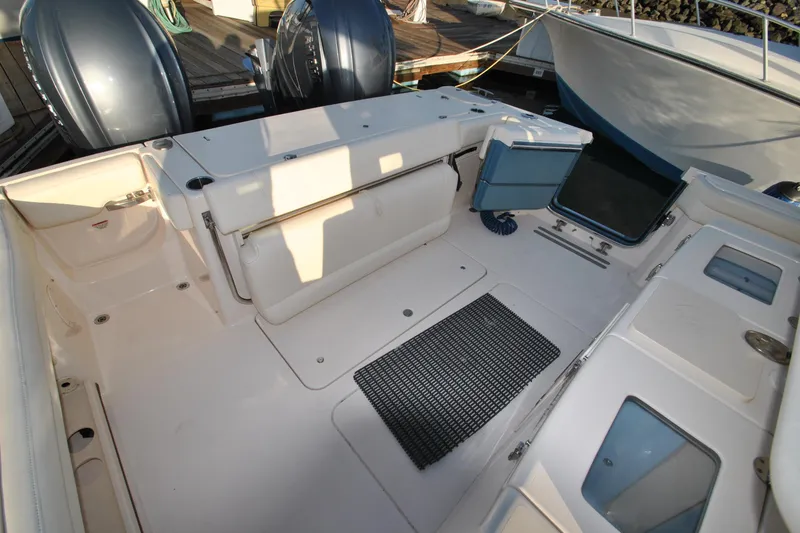 Slide: The Image of 2021 Grady-White Canyon 336 boat deck with storage compartments and twin engines. - 7