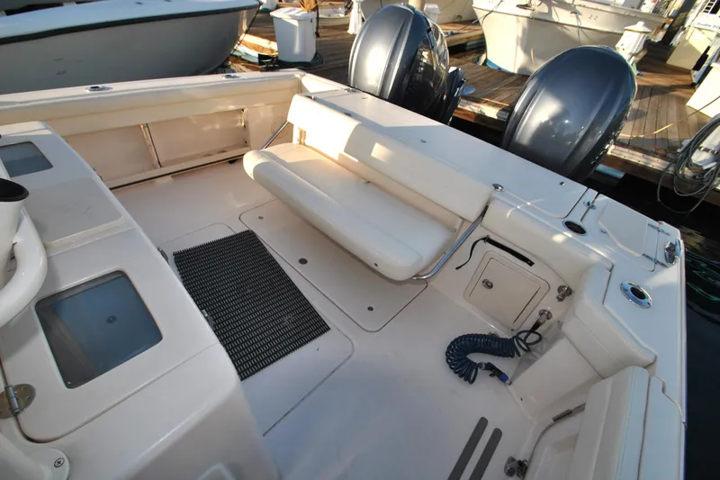 Slide: The Image of 2021 Grady-White Canyon 336 boat interior with seating and twin outboard motors. - 8