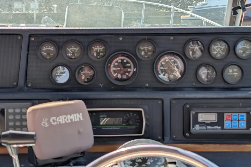 Slide: The Image of Dashboard of a 1987 Sea Ray 390 Express Cruiser with gauges and Garmin device. - 16