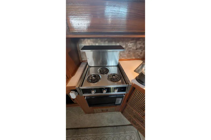 Slide: The Image of Electric stove in 1987 Sea Ray 390 Express Cruiser kitchen area. - 26