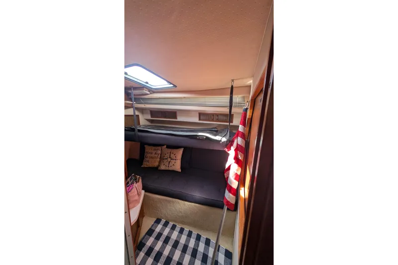Slide: The Image of Interior of 1987 Sea Ray 390 Express Cruiser with cozy seating and nautical decor. - 28
