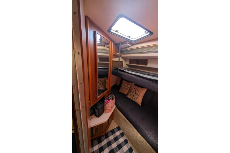 Slide: The Image of Interior of 1987 Sea Ray 390 Express Cruiser with cozy seating and nautical decor. - 29