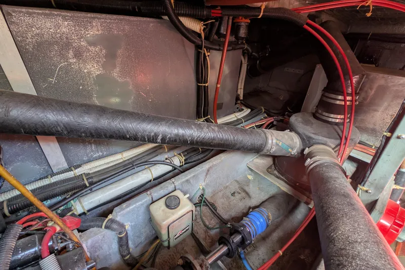 Slide: The Image of Engine compartment of a 1987 Sea Ray 390 Express Cruiser, showing hoses and wiring. - 47