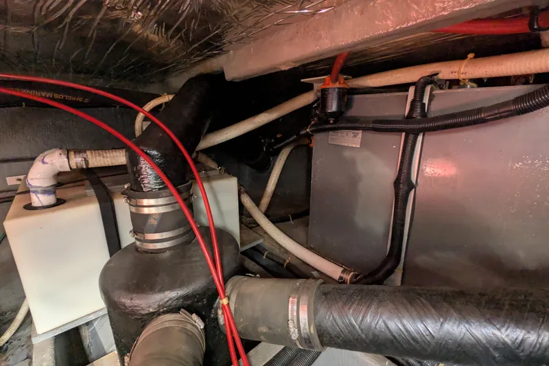 Slide: The Image of Engine compartment of 1987 Sea Ray 390 Express Cruiser with hoses and tanks visible. - 51