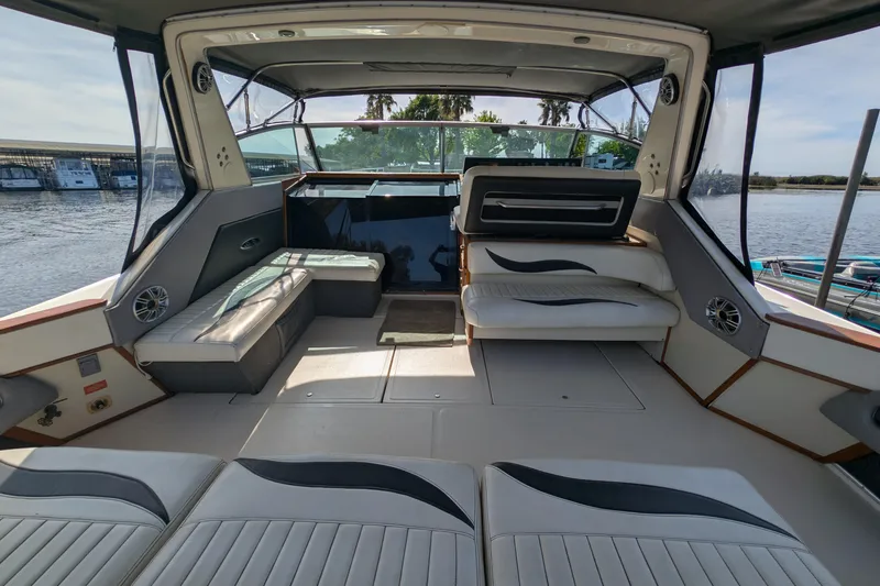 Slide: The Image of 1987 Sea Ray 390 Express Cruiser interior with spacious seating and waterfront view. - 7