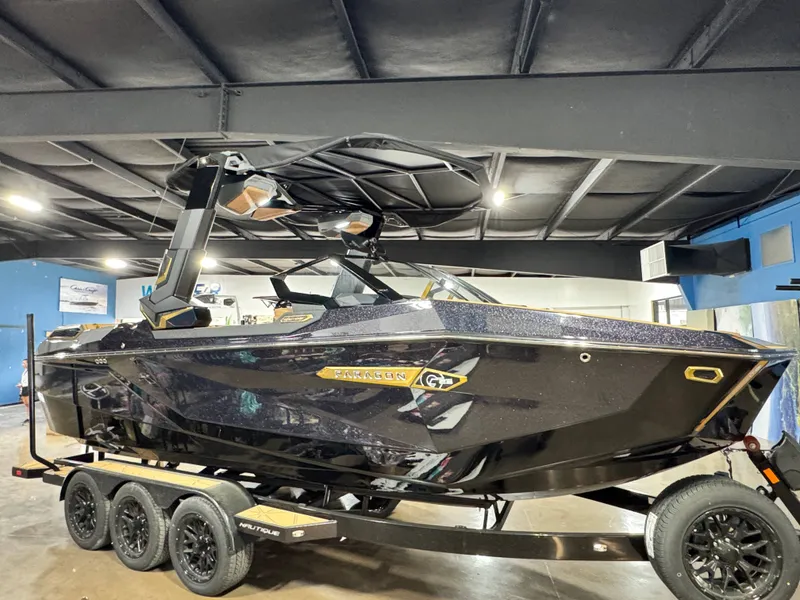 Slide: The Image of 2026 Nautique Super Air Nautique G23 Paragon on trailer in showroom. - 3