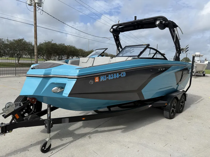 Slide: The Image of 2023 Heyday WT-2DC boat on trailer, blue and black, parked outdoors. - 10