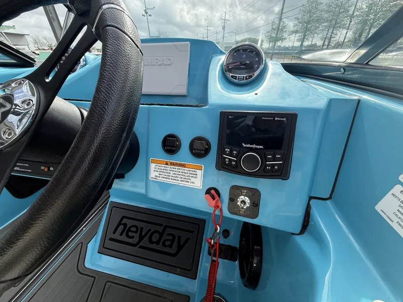 Slide: The Image of Interior view of 2023 Heyday WT-2DC boat cockpit with controls and dashboard. - 7