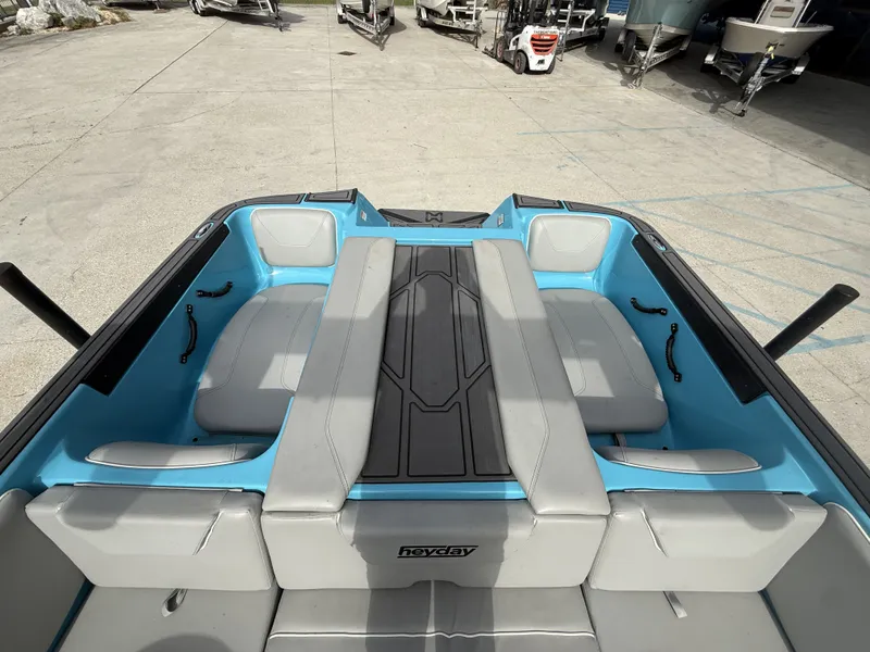 Slide: The Image of Interior of a 2023 Heyday WT-2DC boat with blue and gray seating. - 8