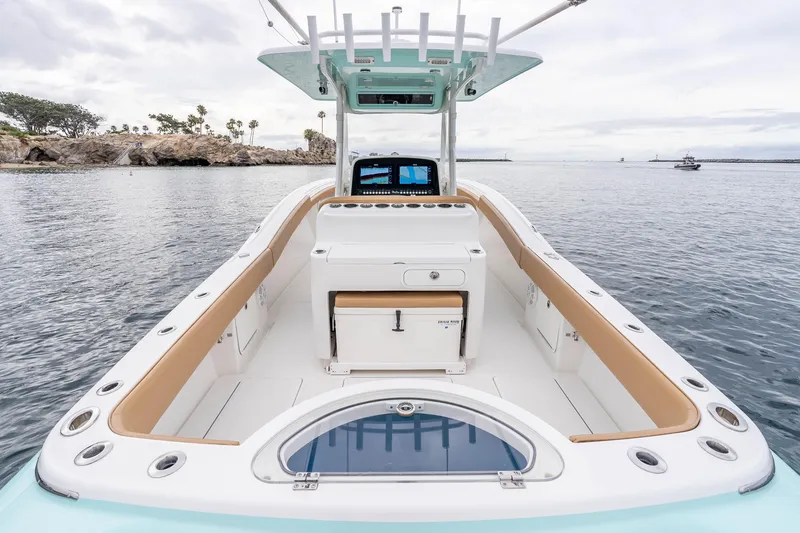 Slide: The Image of 2015 Mag Bay 33 CC boat with spacious deck and modern console on calm water. - 11