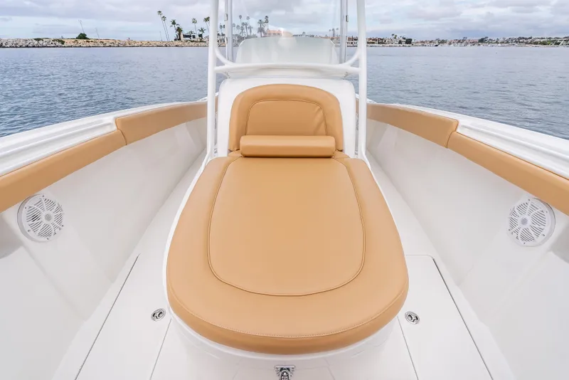 Slide: The Image of 2015 Mag Bay 33 CC boat with tan cushioned seating, docked on calm water. - 20