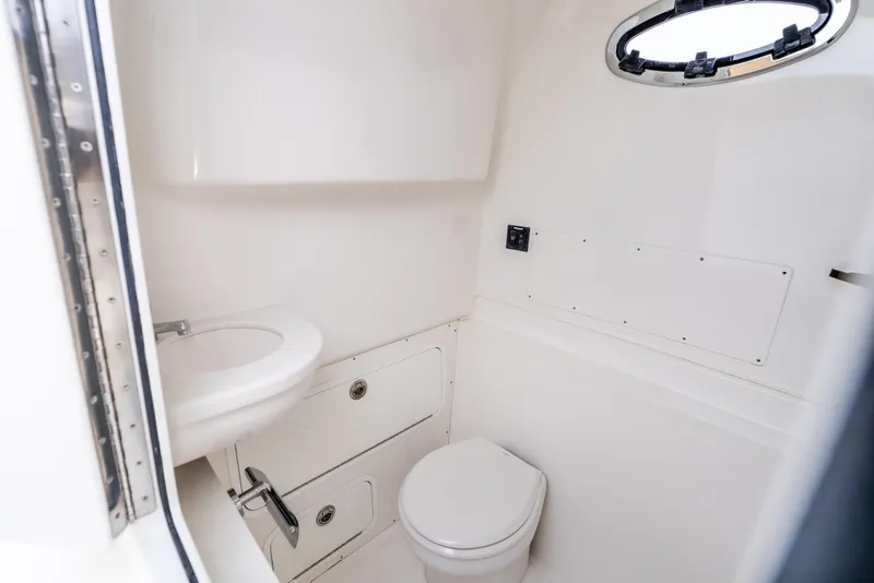Slide: The Image of Interior of 2015 Mag Bay 33 CC boat bathroom with toilet and sink. - 24