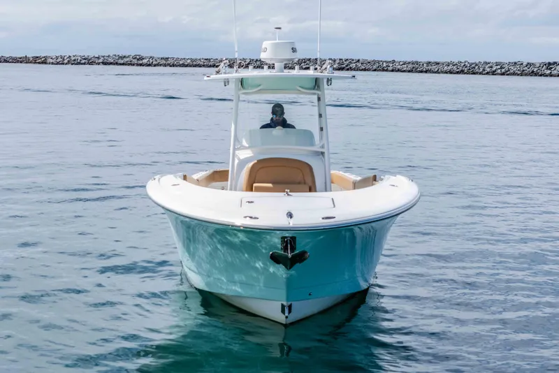Slide: The Image of 2015 Mag Bay 33 CC boat on calm water, front view. - 4