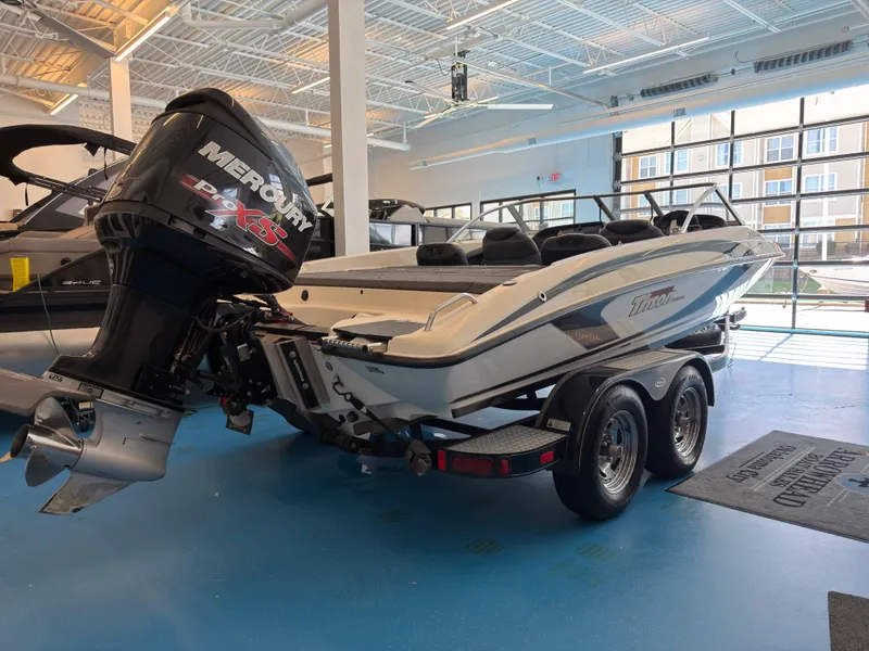 The Image of 2015 Triton 210 Escape boat with Mercury engine in showroom. - 1
