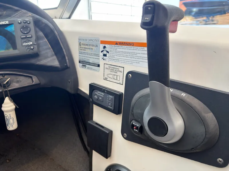 Slide: The Image of Control console of a 2015 Triton 210 Escape boat. - 15