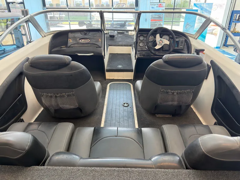 Slide: The Image of Interior of a 2015 Triton 210 Escape boat with black seating. - 16