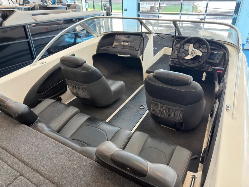 Slide: The Image of Interior of a 2015 Triton 210 Escape boat with black seating. - 19