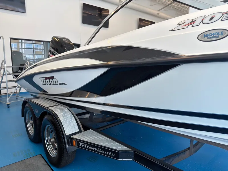 Slide: The Image of 2015 Triton 210 Escape boat on trailer in showroom. - 20
