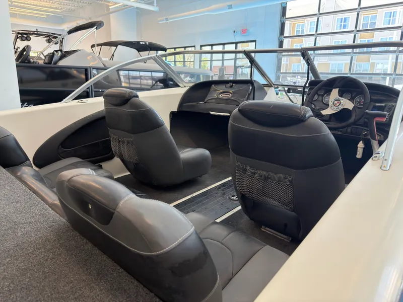 Slide: The Image of Interior of a 2015 Triton 210 Escape boat with black seating. - 23