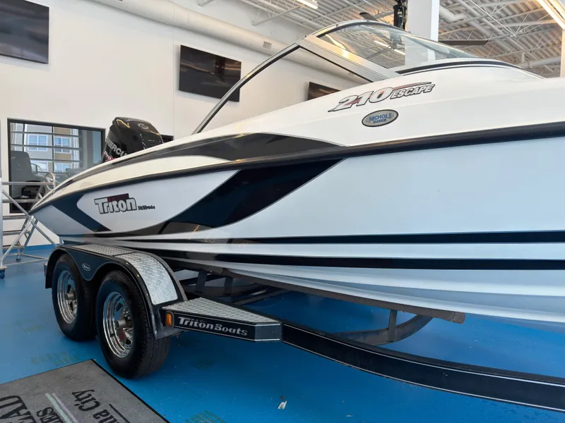 Slide: The Image of 2015 Triton 210 Escape boat in showroom. - 25