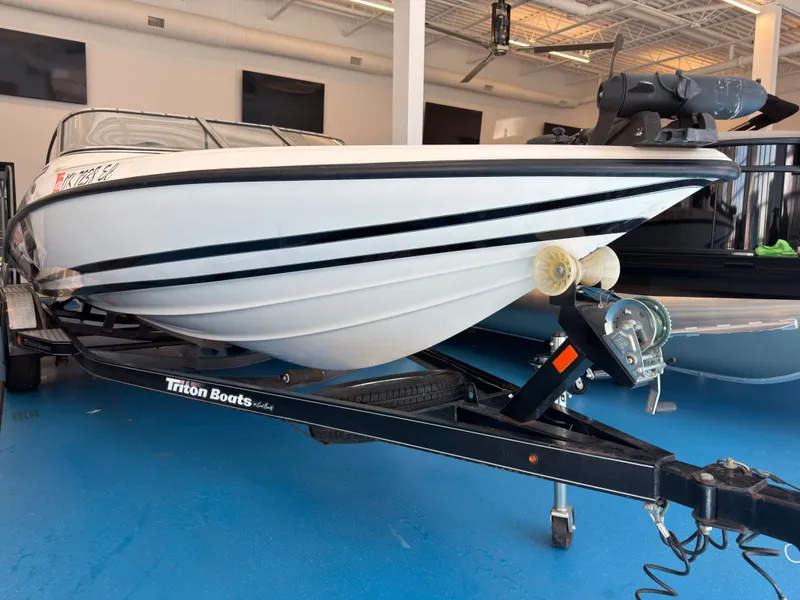 Slide: The Image of 2015 Triton 210 Escape boat on trailer in showroom. - 3