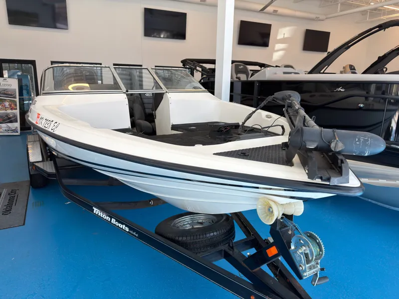 Slide: The Image of 2015 Triton 210 Escape boat in showroom on trailer. - 4