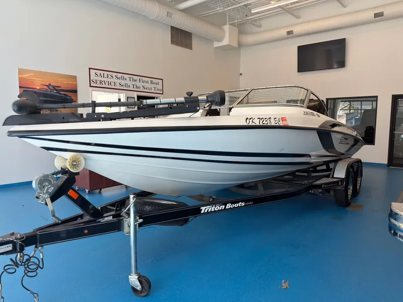 Slide: The Image of 2015 Triton 210 Escape boat on trailer in showroom. - 7