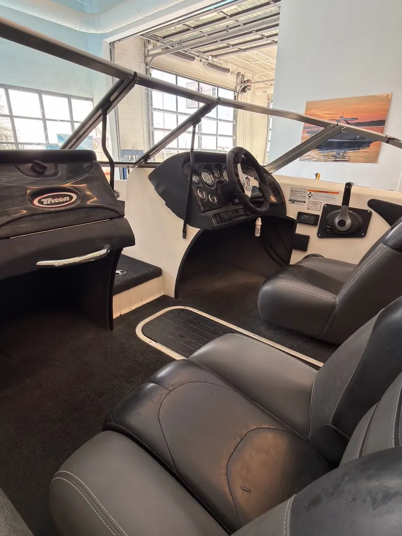 Slide: The Image of Interior of a 2015 Triton 210 Escape boat with steering console. - 9