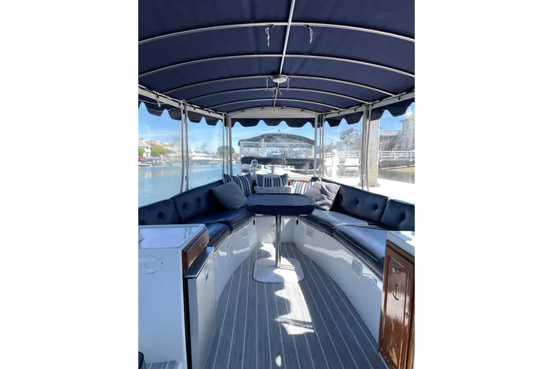 The Image of Interior of 2012 Duffy Bay Island 22 boat with blue canopy and seating. - 2