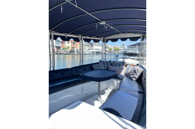 Slide: The Image of Interior of 2012 Duffy Bay Island 22 boat with blue seating and waterfront view. - 4