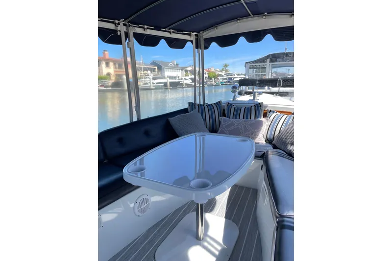 Slide: The Image of Interior of 2012 Duffy Bay Island 22 boat with cushioned seating and waterfront view. - 5