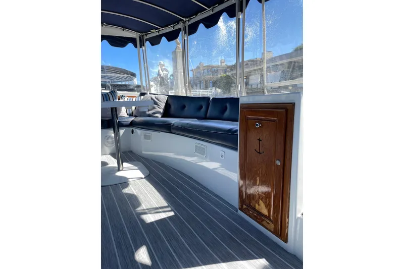 Slide: The Image of Interior of 2012 Duffy Bay Island 22 boat with cushioned seating and wooden cabinet. - 7