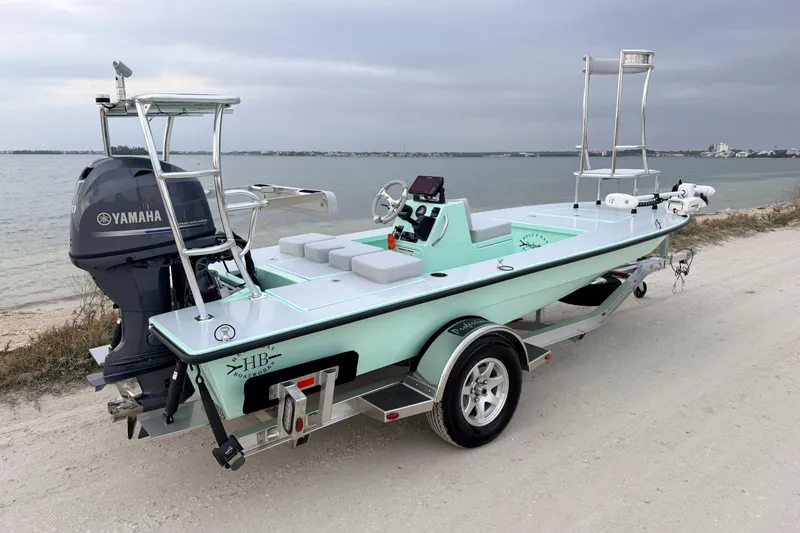The Image of 2025 Hell's Bay Professional boat with Yamaha engine on a trailer by the shore. - 1