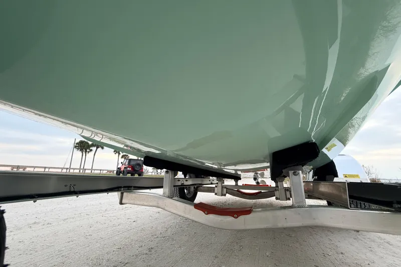 Slide: The Image of Underneath view of a 2025 Hell's Bay Professional boat on a trailer. - 11