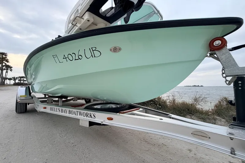 Slide: The Image of 2025 Hell's Bay Professional boat on trailer by the beach, registration FL 4026 UB. - 12