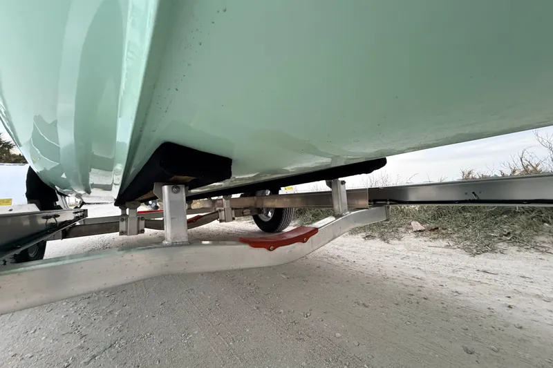 Slide: The Image of Underneath view of a 2025 Hell's Bay Professional boat on a trailer. - 13