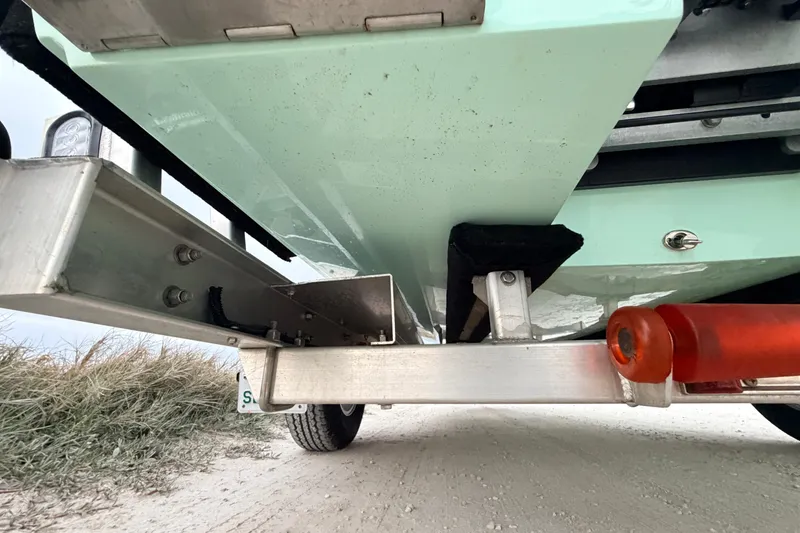 Slide: The Image of Underneath view of a 2025 Hell's Bay Professional boat on a trailer. - 19