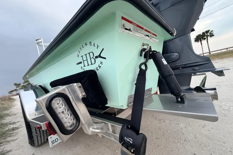 Slide: The Image of 2025 Hell's Bay Professional boat on trailer, showcasing rear design and branding. - 22